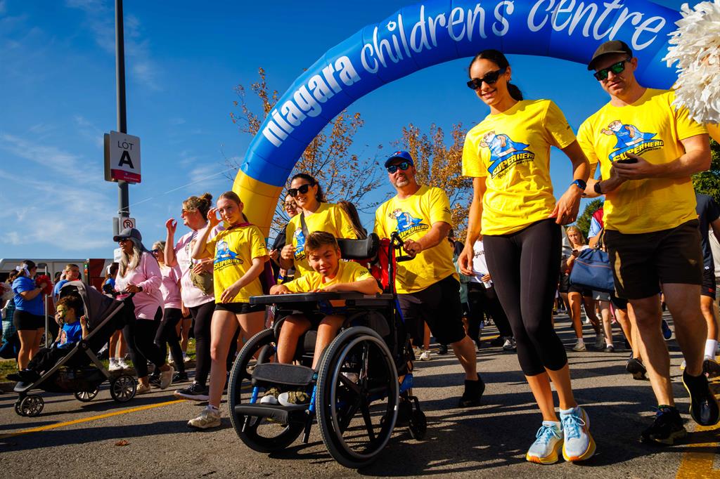 Participants move underneath inflatable arch that reads Niagara Children's Centre