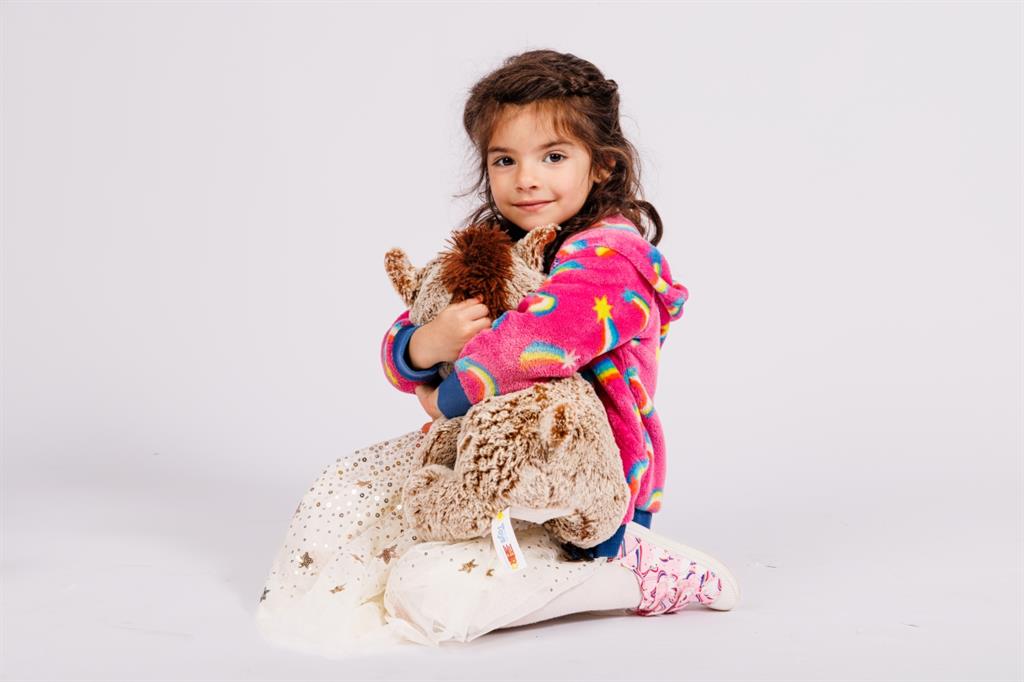 Young girl holding stuffed animal